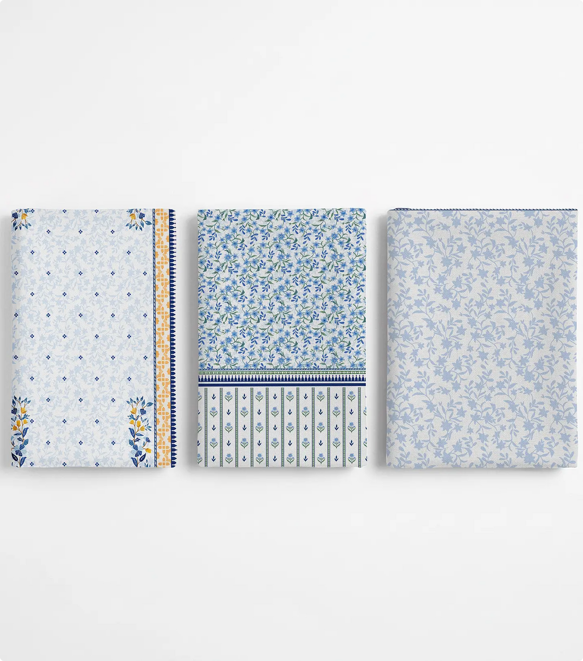 Three folded unstitched ivory and blue lawn pieces with floral prints and mustard borders
