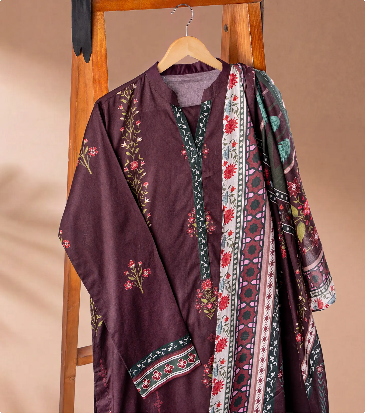 Burgundy lawn shirt with red and green floral print and matching printed dupatta on a wooden hanger