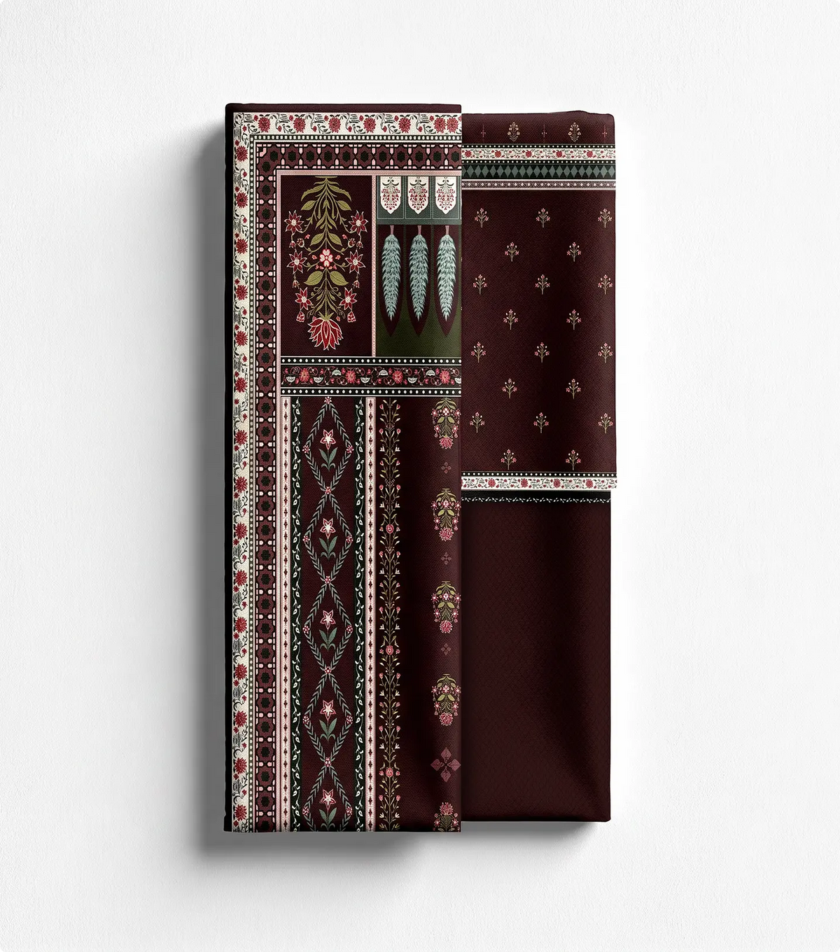 Unstitched burgundy lawn shirt panel with floral border print beside matching trouser fabric